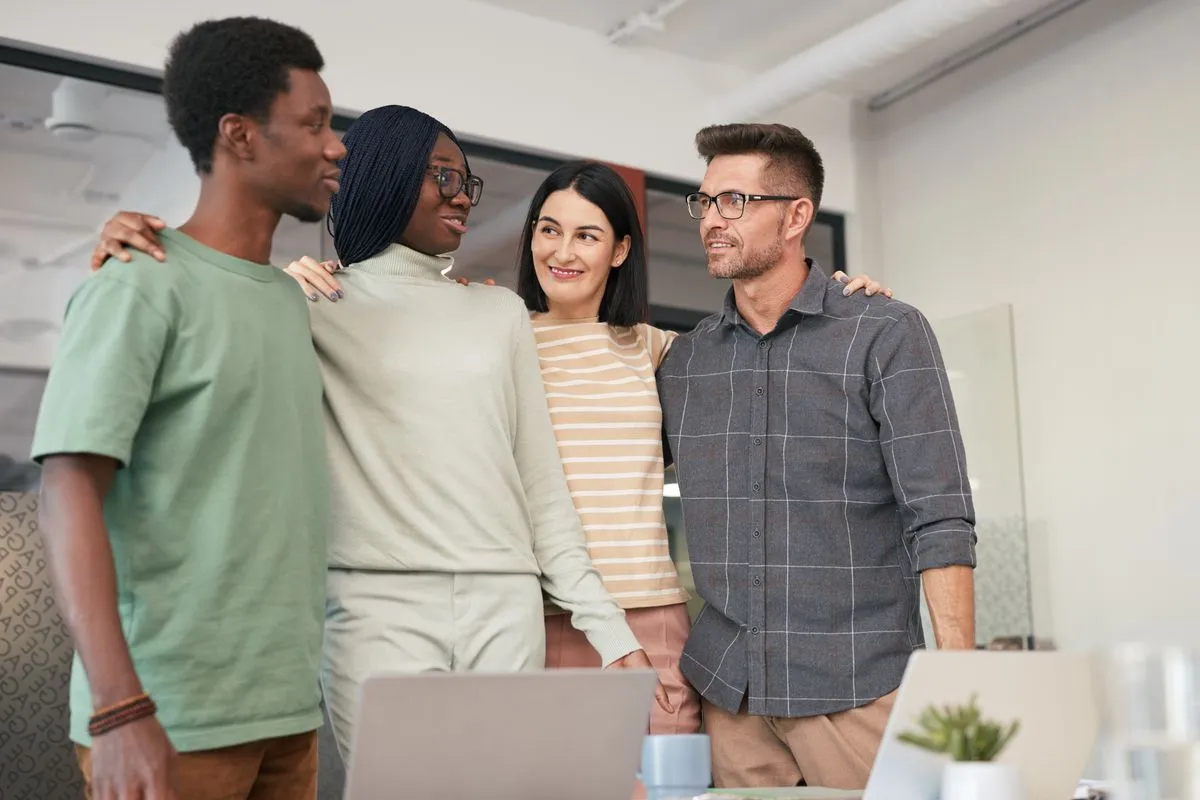 A team celebrating together in a bright office