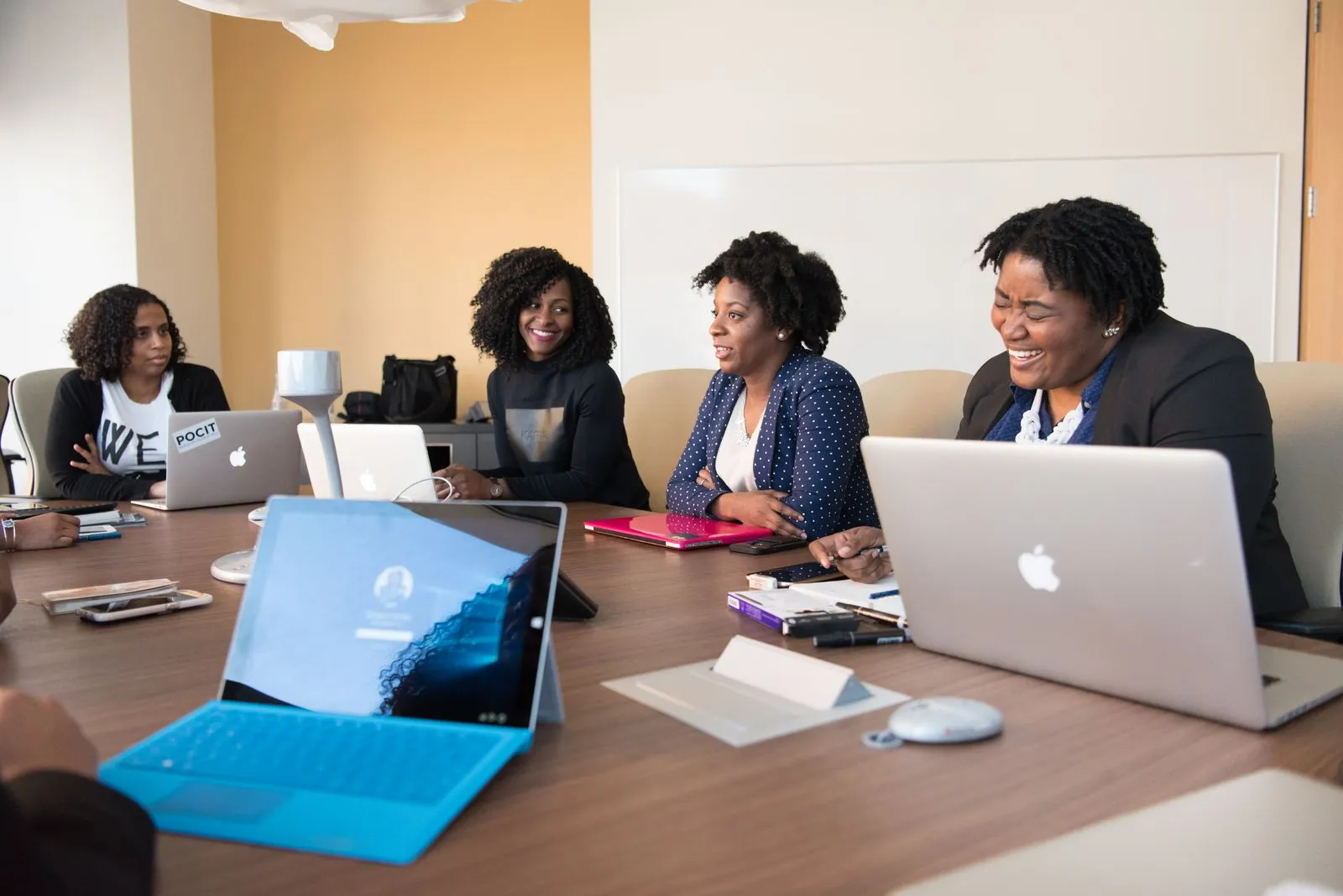 A team leader talking with colleagues around a meeting table